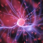 Glowing plasma ball with pink center and electric purple tendrils radiating outward against dark background